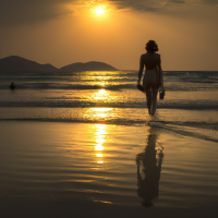 Walking girl on beach at Sun set time